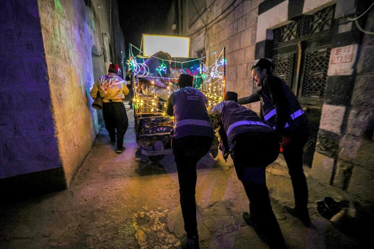In Pictures: Volunteers and a 'Musaharati' Deliver Pre-Dawn Meals in Syria