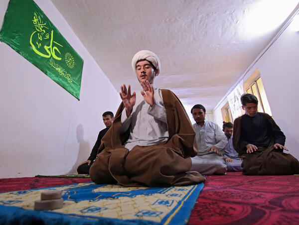 "Afghans, from the Hazara ethnic minority studying at the prestigious "hawza" seminary that trains Shiite clergy, pray in their room in the holy city of Najaf on August 29, 2021."