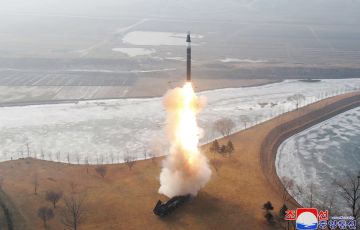 Missile accelerates in sky with bright flame from rocket engine nozzle
