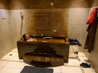 A man bathes in a tub filled with Naftalan crude oil during a treatment session at Qarabag luxury resort in Naftalan, some 300 kilometres (186 miles) from capital Baku, on March 21, 2019. Immersed up to her neck in crude oil, a Russian woman suffering from joint disease smiles in delight, confident that the treatment at a spa in northwestern Azerbaijan will cure her painful condition.  Mladen ANTONOV / AFP
