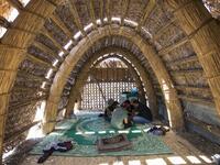Tourists sitting inside a floating palm reed-woven house in the marshes of the southern Iraqi district of Chibayish in Dhi Qar province, about 120 kilometres northwest of the southern city of Basra. Hussein FALEH / AFP