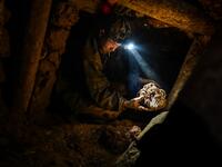 This photo taken on May 16, 2019 shows a miner working in a tunnel in a ruby mine in Mogok, north of Mandalay. Burrowing deep underground, thousands of informal miners risk their lives to find gleaming red gems as a law change spurs opportunity in Myanmar's "land of rubies". Ye Aung THU / AFP