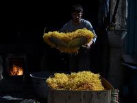 An Afghan worker prepares seemian, a local snack food made from flour and chilli, ahead of the Eid al-Fitr festival, which marks the end of Islamic holy month of Ramadan, at a traditional sweets factory in Kabul on June 2, 2019. WAKIL KOHSAR / AFP