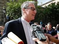 A member of the church answers journalists questions prior to entering the Notre-Dame de Paris cathedral, to take part in a mass, the first since the fire that destroyed the cathedral's roof on April 15, in Paris on June 15, 2019. Zakaria ABDELKAFI / AFP