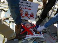 Palestinians stamp on protest signs showing the crossed-out faces of (L to R)  Israeli Prime Minister Benjamin Netanyahu, US President Donald Trump,  King Hamad al-Khalifa of Bahrain, and Saudi Crown Prince Mohammed bin  Salman, with a caption above in Arabic reading "Palestine is not for sale,  no to the conference of shame in Bahrain, the deal of the century will not pass". Musa Al SHAER / AFP