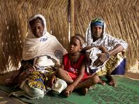Dicko Sidibe (R) poses with her daughter and her sister Soutra (L) in a refugee camp on May, 13, 3019 in Bamako. After receiving several threats and attacks against their village in the province of Bankass, they fled central Mali to find a safe place in Bamako. (MICHELE CATTANI / AFP)