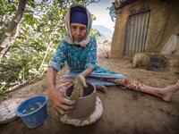 Moroccan potter Fatima Harama from the M'tioua tribe works on pottery near the village of Ourtzagh in the region of Taounate on june 11, 2019 The Sumano association, which promotes Moroccan tribal women's handicrafts, places orders with the potters, buys the works, transports them to Spain and sells them at 20 times the local price on its website, promising to redistribute the income locally "when the business becomes profitable". FADEL SENNA / AFP