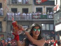 A reveller celebrates during the 'Chupinazo' (start rocket) to mark the kickoff at noon sharp of the San Fermin Festival, in front of the Town Hall of Pamplona, northern Spain, on July 6, 2019.  ANDER GILLENEA / AFP