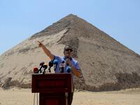 Egypt's Antiquities Minister Khaled El-Enany speaks in front of the Bent Pyramid of Sneferu during an inaugural ceremony of the pyramid and its satellites, on July 13, 2019. Mohamed el-Shahed / AFP