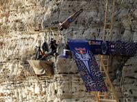 A cliff diver jumps from a platform on the landmark Raouche sea rock off the coast of the Lebanese capital Beirut on July 14, 2019, during the men's 2019 Red Bull Cliff Diving World Series.  ANWAR AMRO / AA / AFP