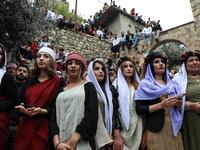 Iraqi Yazidi women light candles outside the Temple of Lalish, in a valley near the Kurdish city of Dohuk about 430 kilometres northwest of the capital Baghdad, on April 16, 2019, during a ceremony marking the Yazidi New Year. SAF