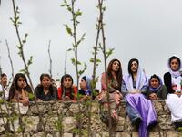 Iraqi Yazidi women sit outside the Temple of Lalish, in a valley near the Kurdish city of Dohuk about 430 kilometres northwest of the capital Baghdad, on April 16, 2019, during a ceremony marking the Yazidi New Year. SAFIN HAMED /