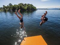 People plunge into the water of the newly opened Bekkelagsbadet in Oslo, between Mosseveien and the bridge over Ormoya, on July 23, 2019, as a new heatwave hits Europe.  Trond Reidar Teigen / NTB scanpix / AFP