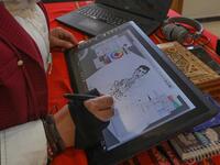 Syrian cartoonist Amani al-Ali sketches a portrait of President Bashar al-Assad in her home studio in the city of Idlib in the eponymous northwestern province.  Omar HAJ KADOUR / AFP