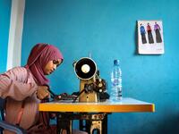 Hawa Adan Hassan, 23 year-old, university student, uses a sewing machine at her home in Mogadishu, Somalia. Abdi HAJJI HUSSEIN / AFP