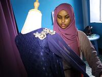 Hawa Adan Hassan, a 23 year-old university student and a young Somali female fashion designer checks her new finished fashion design, on November 3, 2018, in Mogadishu. Abdi HAJJI HUSSEIN / AFP