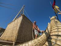A member of the crew assembles the 14-meter long sailing reed boat Abora IV in the town of Beloslav, Bulgaria, on July 25, 2019. NIKOLAY DOYCHINOV / AFP