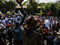 Catholic faithful smeared in burnt oil, take part in the opening of the ten-day celebration of the Santo Domingo de Guzman festival in Managua, on August 1, 2019.  INTI OCON / AFP