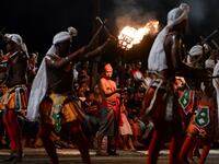 In this photograph taken on August 14, 2019 dancers perform during the "Esala Perahera" festival near the Buddhist temple of the Tooth in the ancient hill capital of Kandy, some 116 kilometres from Colombo. Lakruwan WANNIARACHCHI / AFP