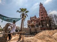 This picture taken on August 18, 2019 shows restoration works ongoing at the historic "Le Palais Hindou" (also known as the "Baron Empain Palace") built by in the early 20th century by Belgian industrialist Edouard Louis Joseph, Baron Empain, in the classical Khmer architectural style of Cambodia's Angkor Wat, in the Egyptian capital Cairo's northeastern Heliopolis district.  Khaled DESOUKI / AFP