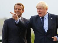 British Prime Minister Boris Johnson (R) gestures past French President Emmanuel Macron at the Biarritz lighthouse, southwestern France, ahead of a working dinner on August 24, 2019. Francois Mori / POOL / AFP