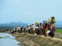October 19, 2017 Rohingya refugees who were stranded walk near the no man's land area between Bangladesh and Myanmar in the Palongkhali area next to Ukhia. Munir UZ ZAMAN / AFP