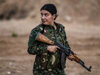 A member of the Bethnahrin Women Protection Forces (HSNB), an all-female Syriac-Assyrian paramilitary group under the umbrella of the Syrian Democratic Forces (SDF), lines up as the group commemorates the fourth anniversary of its creation, in the countryside of the town of Tall Tamr in the northwestern Syrian province of Hasakah, on August 30, 2019.  Delil SOULEIMAN / AFP