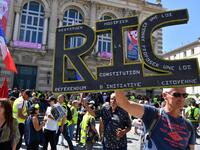 A protester holds a sign reading "RIC" (for "Citizen's Initiated Referendum") during an anti-government demonstration called by the "Yellow Vests" (Gilets Jaunes) movement on September 7, 2019 in Montpellier, southern France. Pascal GUYOT / AFP