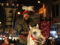 Iraqi Shiites in costumes re-enact events of Ashura in the capital Baghdad's mostly Shiite neighbourhood of Kadhimiya, marking the 8th day of Muharram.  Ahmad AL-RUBAYE / AFP