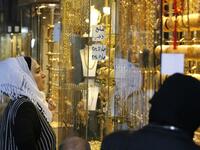 Women gaze at the window of a jewelry shop at the Bzourieh market in the centre of the Syrian.  LOUAI BESHARA / AFP