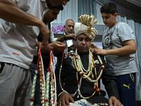 In this photo taken on September 15, 2019, a groom is garlanded by relatives and friends before leaving for his bride's home in Kashmir's Baramulla district, north of Srinagar. TAUSEEF MUSTAFA / AFP