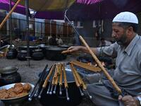 In this photo taken on September 15, 2019, chefs prepare long kebabs made from minced meat ahead of a traditional feast held for a marriage ceremony in Kashmir's Baramulla district, north of Srinagar. TAUSEEF MUSTAFA / AFP