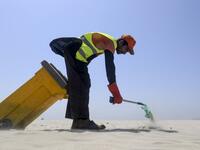 A worker of Cantonment Board Clifton (CBC) collects plastic and other waste from the Clifton beach in Karachi on September 19, 2019. ASIF HASSAN / AFP