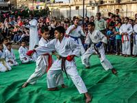 Young Palestinian karatekas demonstrate their skills during a Karate promotion ceremony at a sporting centre in the Rafah camp for Palestinian refugees in the southern Gaza Strip on September 20, 2019. SAID KHATIB / AFP