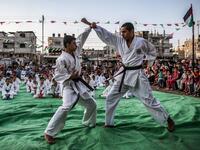 Young Palestinian karatekas demonstrate their skills during a Karate promotion ceremony at a sporting centre in the Rafah camp for Palestinian refugees in the southern Gaza Strip on September 20, 2019. SAID KHATIB / AFP