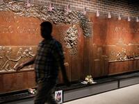 People walk by a memorial to fallen firefighters near the World Trade Center Memorial in lower Manhattan in New York City. New York City is preparing to commemorate the 18th anniversary of the attacks on the World Trade Center in which 2,996 people were killed and over 6000 were injured. Spencer Platt/Getty Images/AFP SPENCER PLATT / GETTY IMAGES NORTH AMERICA / AFP