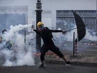 A protester throws a tear gas canister fired by police in the Sha Tin district of Hong Kong on October 1, 2019, as the city observes the National Day holiday to mark the 70th anniversary of communist China's founding. ISAAC LAWRENCE / AFP