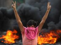 An Iraqi protester flashes the v-sign during a demonstration against state corruption, failing public services and unemployment in the Baladiyat district of the capital Baghdad on October 2, 2019. Iraq's president and the United Nations urged security forces to show restraint after two protesters were killed in clashes with police that other top officials blamed on "infiltrators." AHMAD AL-RUBAYE / AFP