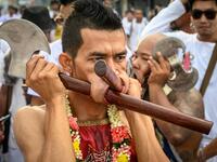 The festival begins on the first evening of the ninth lunar month and lasts for nine days, with many religious devotees slashing themselves with swords, piercing their cheeks with sharp objects and committing other painful acts to purify themselves, taking on the sins of the community. Mladen ANTONOV / AFP