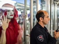 A protestor (L) takes part in a demonstration called by climate change activist group Extinction Rebellion, in front of the lobby of the building where the Bayer-Monsanto office is located in Buenos Aires on October 7, 2019. The year-old group Extinction Rebellion has energised a global movement demanding governments drastically cut the carbon emissions that scientists have shown to cause devastating climate change. RONALDO SCHEMIDT / AFP