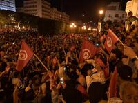 Tunisians gather to celebrate the victory of Kais Saied in the Tunisia's presidential runoff on October 13, 2019, in the capital Tunis. Conservative academic Kais Saied, a political outsider, won a landslide victory Sunday in Tunisia's presidential runoff, sweeping aside his rival, media magnate Nabil Karoui, state television said. Fethi Belaid / AFP
