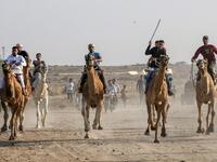 Palestinian jockeys compete during a local camel race held at the destroyed Gaza airport, in Rafah in the southern Gaza Strip on October 20, 2019. SAID KHATIB / AFP