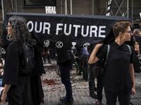 Environmental activists participate in a die-in during a rally for action against climate change in the Financial District October 7, 2019 in New York City. The group 'Extinction Rebellion' has organized protests and sit-ins around the globe today to push for action against climate change. Drew Angerer/Getty Images/AFP D