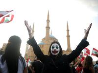 A Lebanese demonstrator, her face painted as DC comic book and film character "The Joker", takes part in a protest in the capital Beirut's downtown district's Martyr's Square (Twitter)