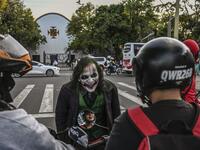 Venezuelan migrant Johnny Tales, who makes a living imitating the comicbook and film character "The Joker", performs at a traffic light in Medellin, on October 29, 2019. JOAQUIN SARMIENTO / AFP