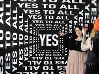 A woman is being photographed at the "Supercandy Pop-Up Museum Vol. 2" in Cologne, western Germany on November 1, 2019. It is an interactive museum and offers a photo backdrop for social media at 25 stations. INA FASSBENDER / AFP