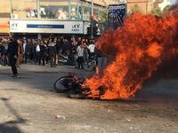 Iranian protesters gather around a burning motorcycle during a demonstration against an increase in gasoline prices in the central city of Isfahan, on November 16, 2019. AFP