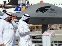 Men walk past a Chinese-made CAIG Wing Loong II medium altitude long endurance (MALE) unmanned aerial vehicle (UAV), on display during the 2019 Dubai Airshow on November 18, 2019. KARIM SAHIB / AFP