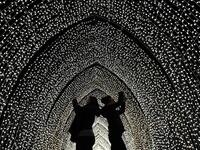 Visitors walk through the 'By Frost' tunnel of lights during a photocall at Kew Gardens in south west London, on November 19, 2019, during an event to promote the launch of the "Christmas at Kew" event. The Christmas at Kew trail is illuminated with numerous light-art installations especially commissioned. Daniel LEAL-OLIVAS / AFP