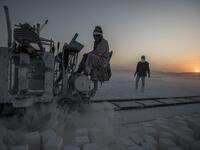 Labourers work at the "White Mountain" limestone extraction quarry site near Egypt's southern city of Minya, some 265 kilometres south of the capital, on November 13, 2019. Covered in fine white dust, labourers at the so-called "White Mountain" off Minya toil in shifts amidst brutal conditions with little workplace safety for paltry pay. They handle dangerous machinery with finesse, and shrug off the dangers of a job where a mistake can prove fatal. Khaled DESOUKI / AFP